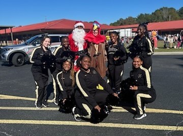 Santa and the turkey posing with the dance team