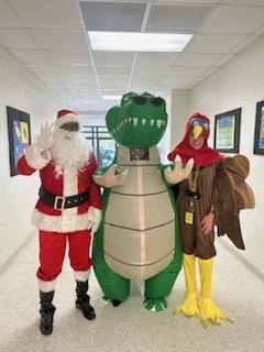 Administrators from GCE and GCH posing with an inflatable alligator