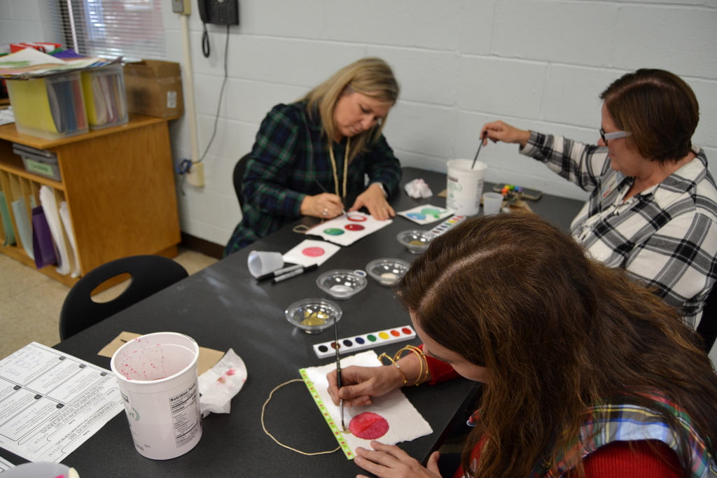 HHA teachers painting with water colors at a professional development 