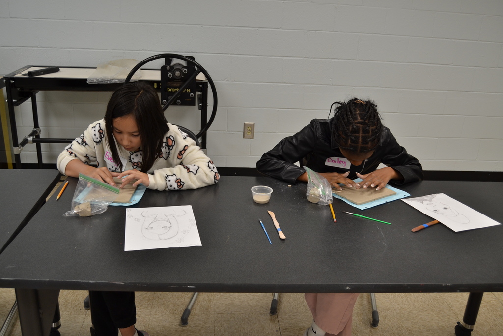 5th grade students creating their clay portraits