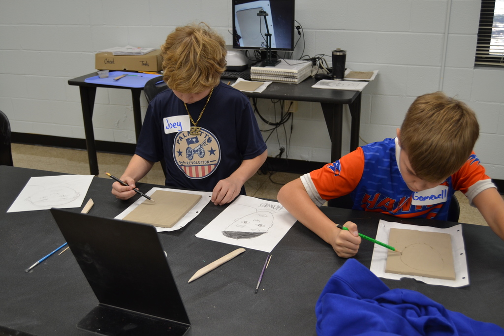 5th grade students creating their clay portraits