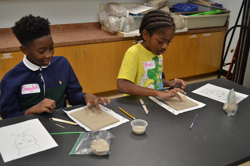 5th grade students creating their clay portraits