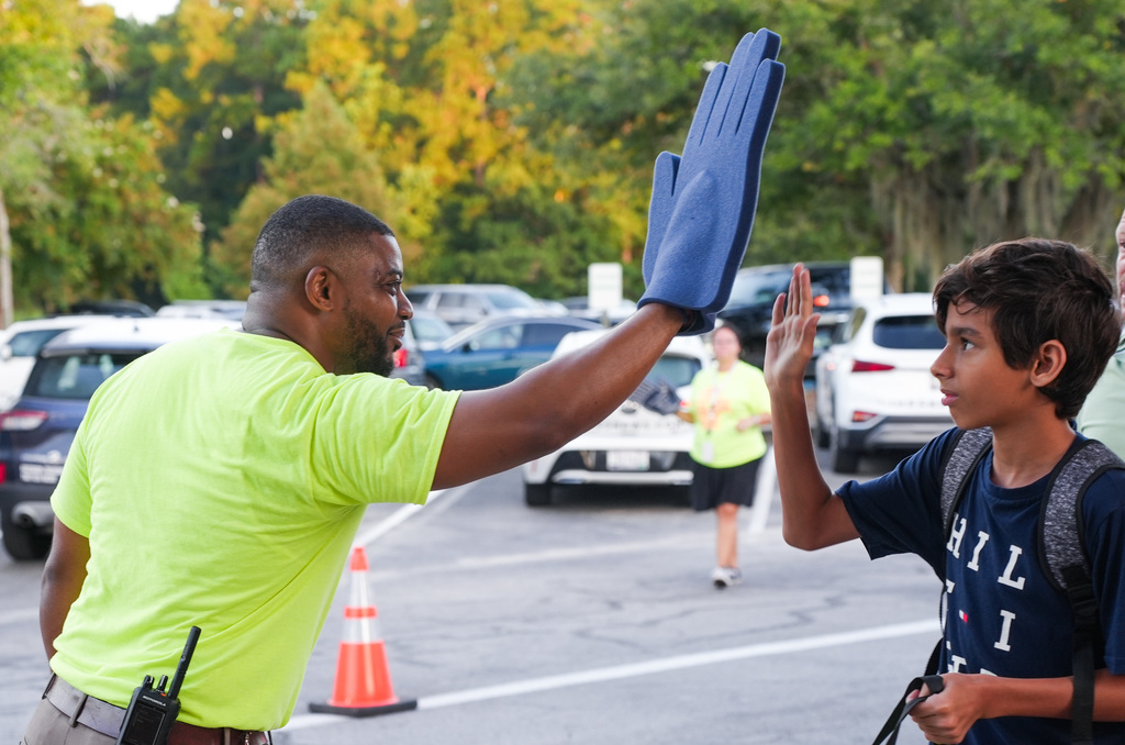 teacher high fiving student