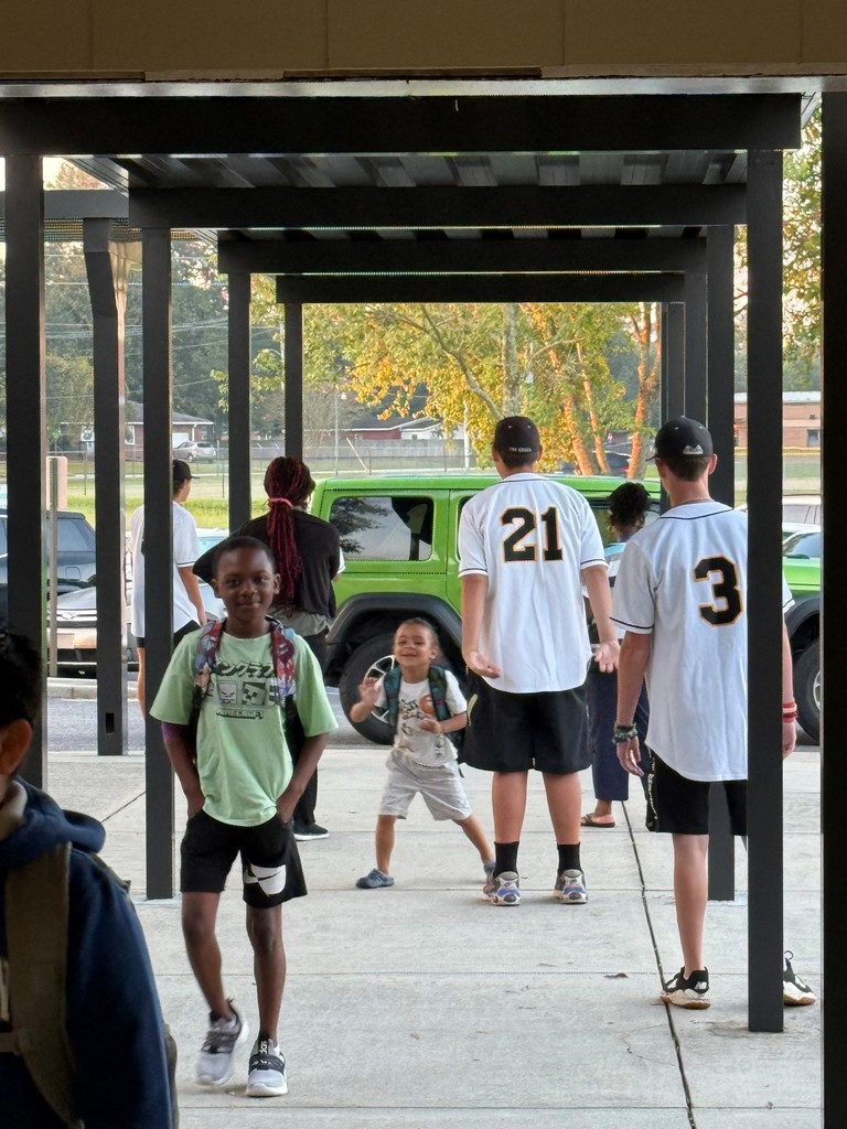 GCH Baseball players greet MHE students as they arrive at school.