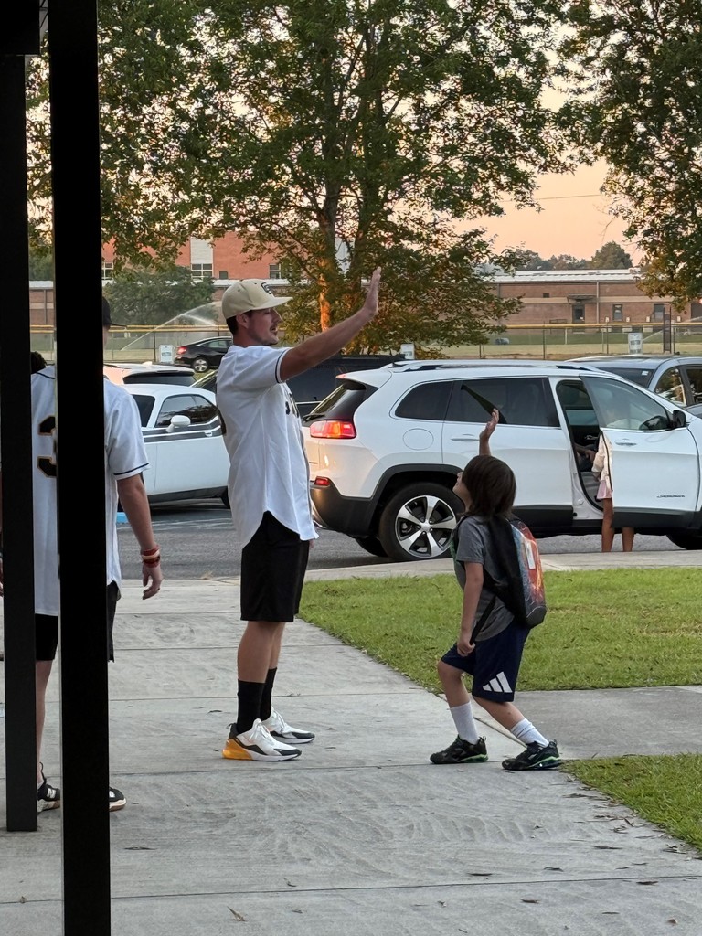 GCH Baseball players greet MHE students as they arrive at school.