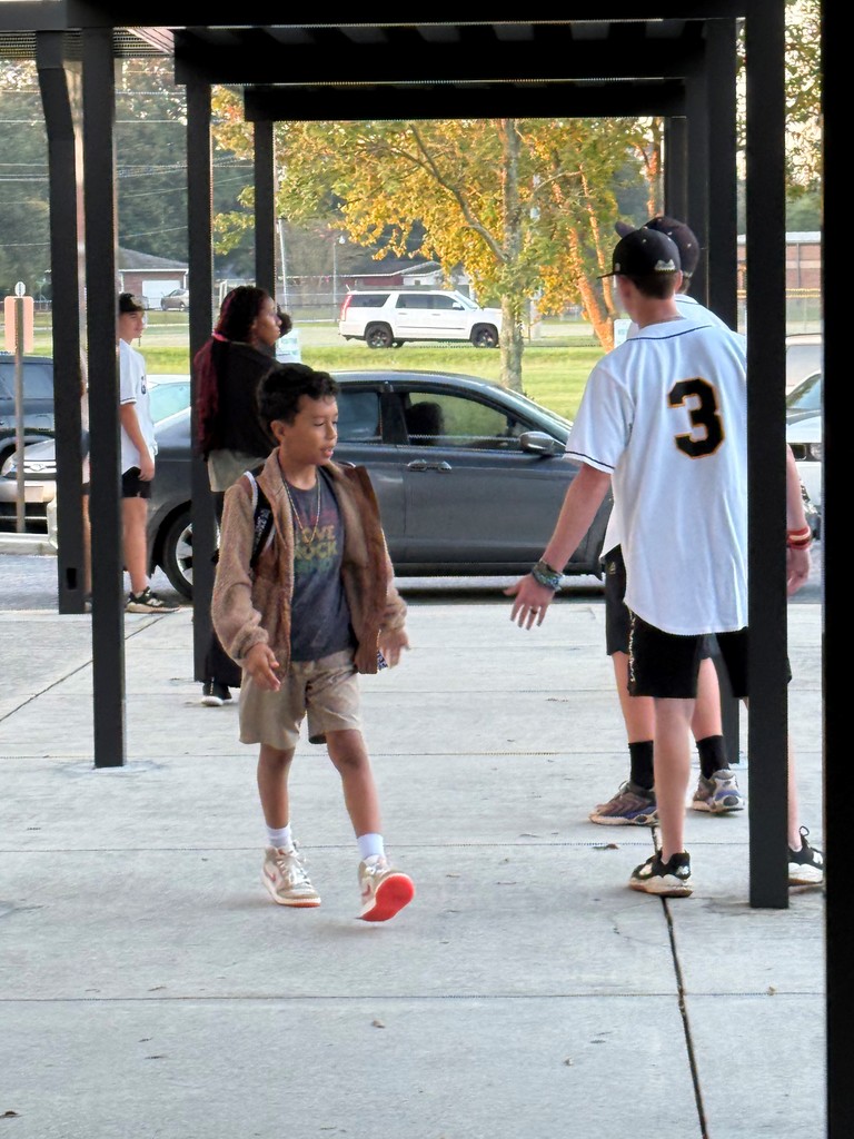 GCH Baseball players greet MHE students as they arrive at school.