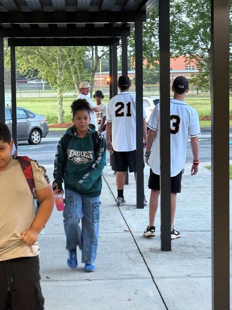 GCH Baseball players greet MHE students as they arrive at school.