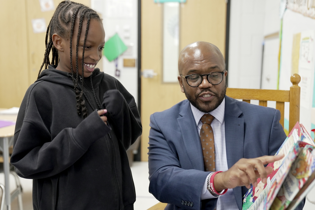 student reading with Dr. Dixon