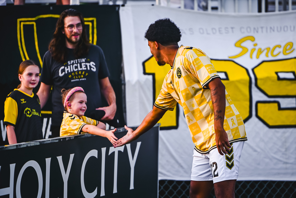 student high fiving soccer player