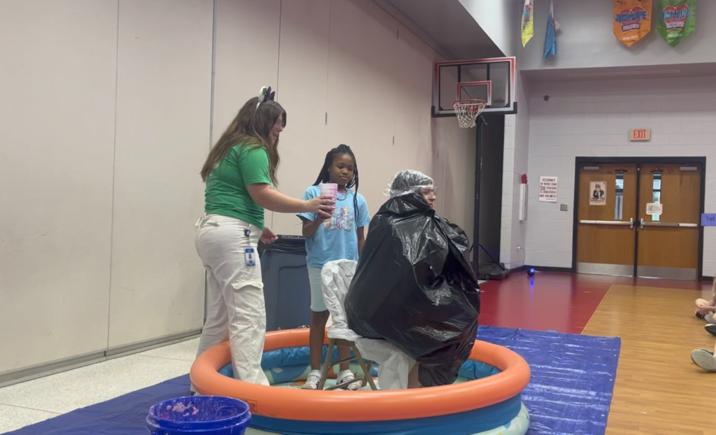 Student space sliming a teacher, 4th grade student