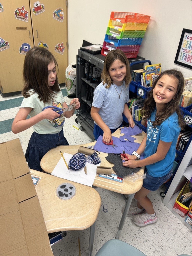 The girls work together to create a shield for their cabin group.