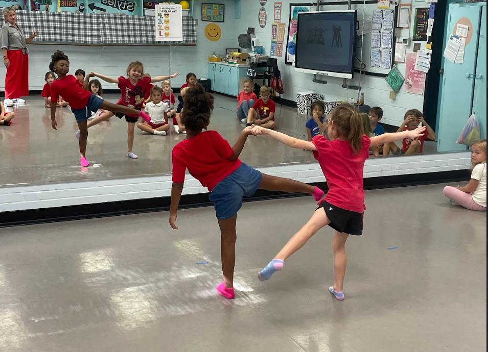 Two students forming a shape during dance infusion