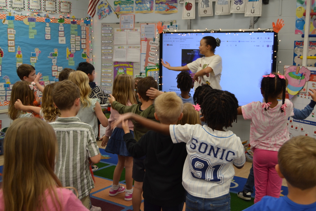 Students dancing with an artist in residence