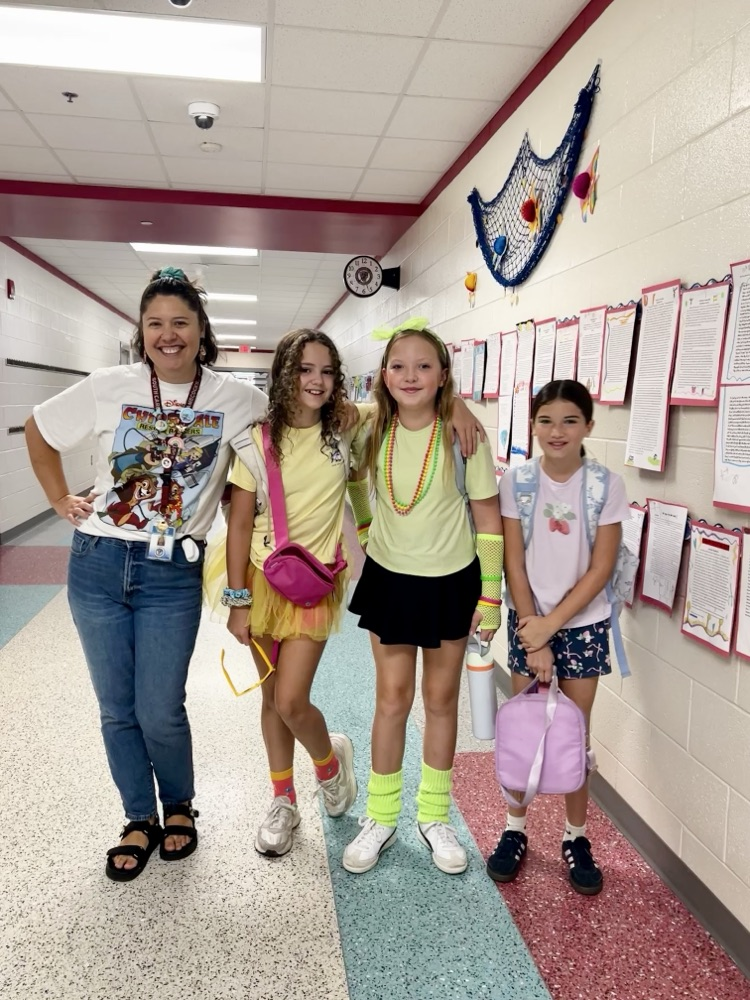 teacher smiling with students 