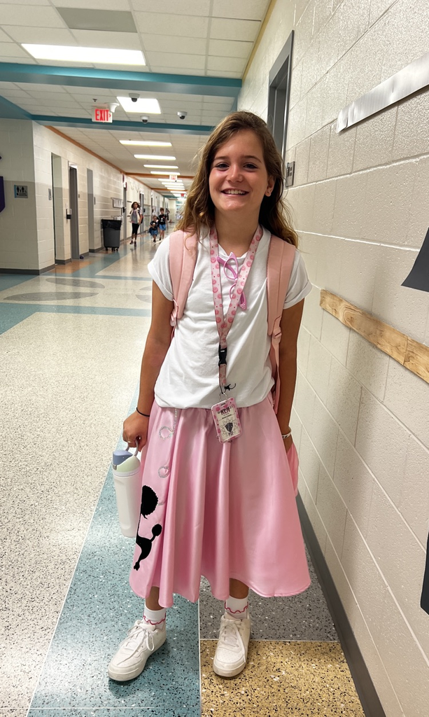 girl in pink skirt smiling 