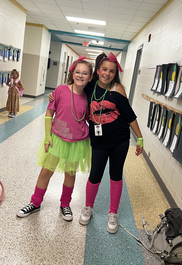 kids in neon work out clothes smiling 