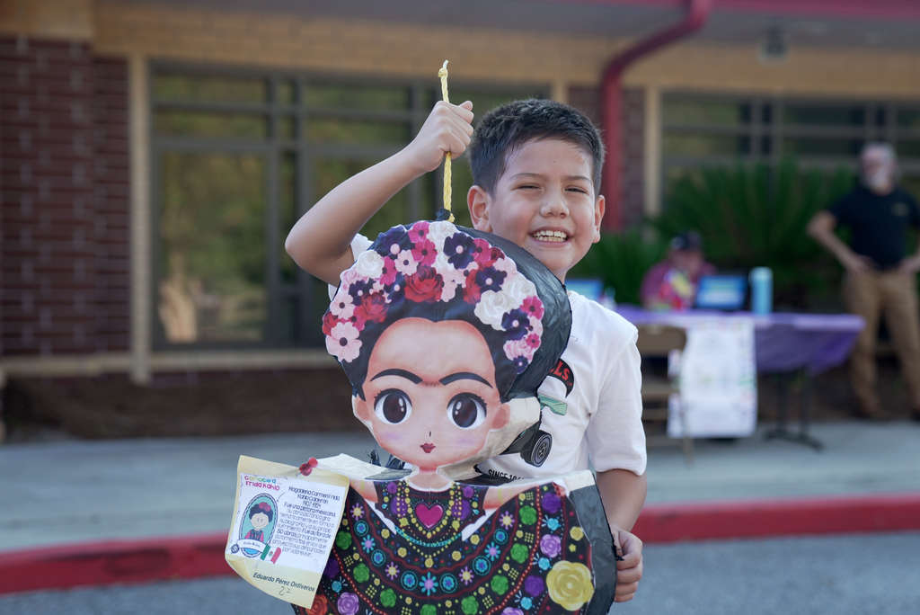 student showing off pinata project