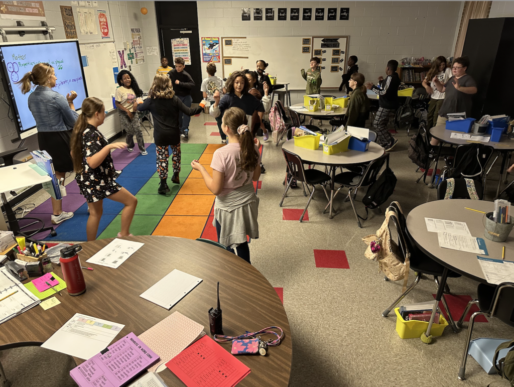 photo of students in 5th grade classroom using movement to learn about states of matter!