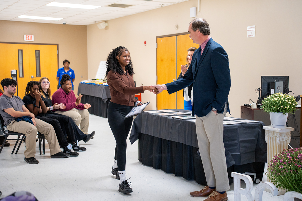 student in receiving line