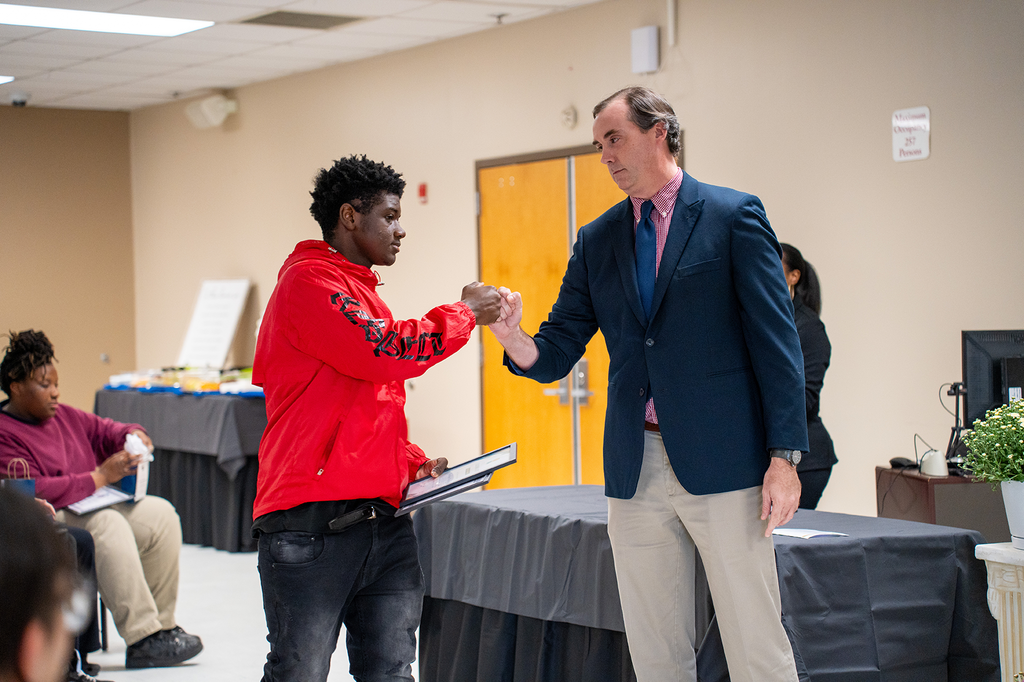 Jonah Bryant fist bumps student