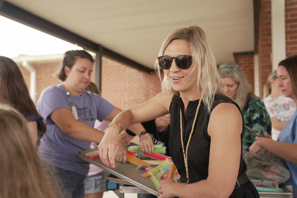teacher handing out popsicle