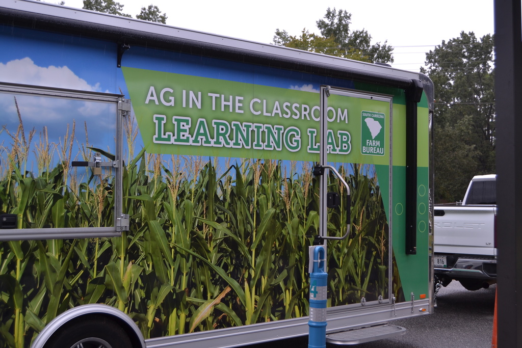 Side of a truck that says AG in the Classroom Learning Lab