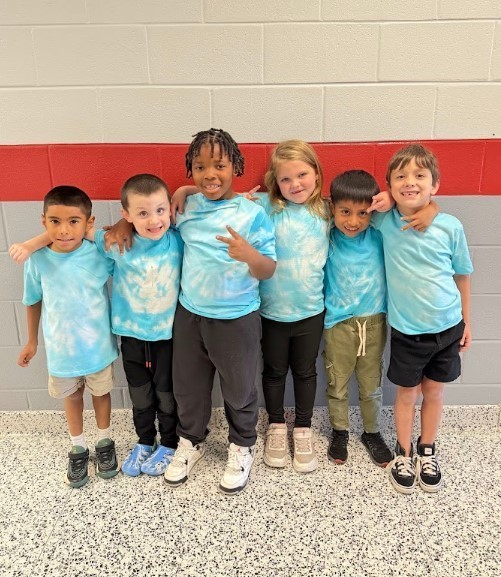group of students in matching tye dye blue shirts for twin day