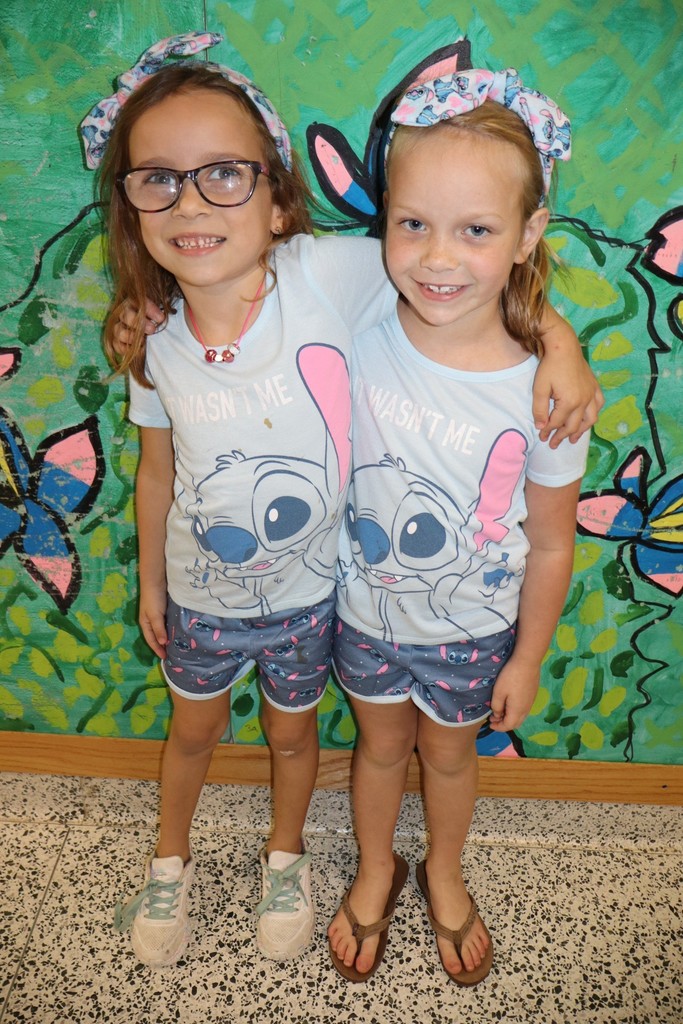 Two female students dressed in matching stitch shirts 