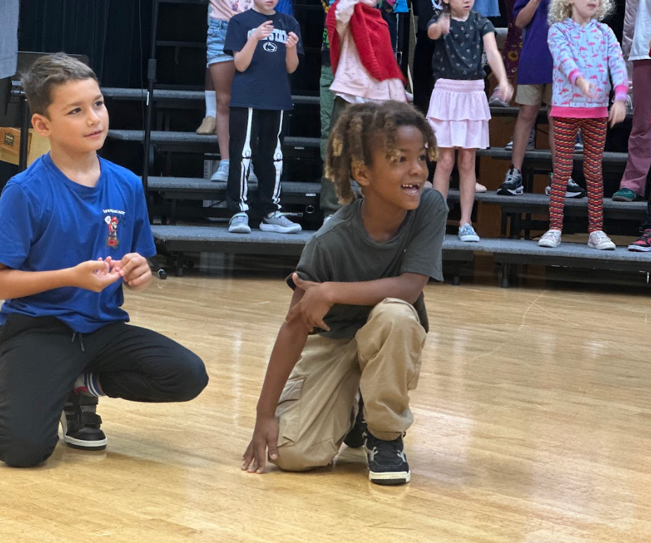 Students posing during a dance in a musical rehearsal