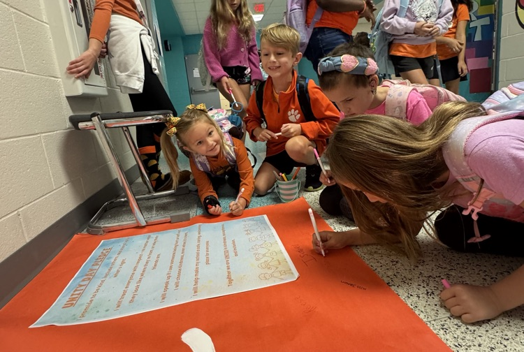 students signing poster 