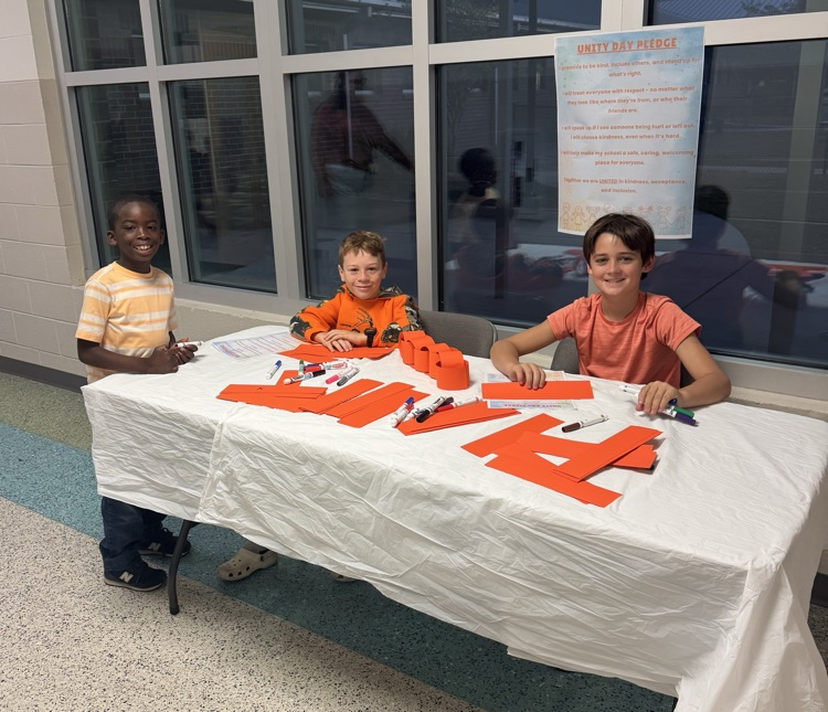 students at table with orange links 