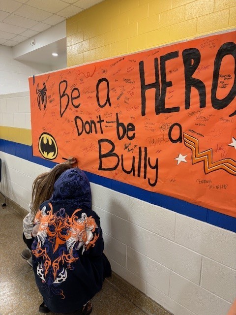 kids signing anti-bully banner