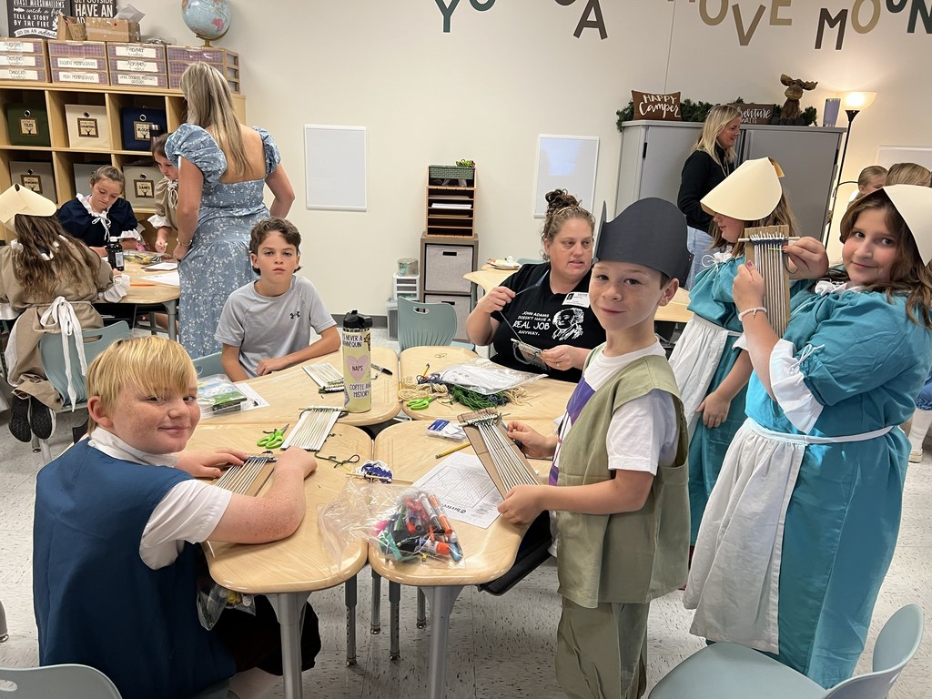 Students practiced weaving on their looms.