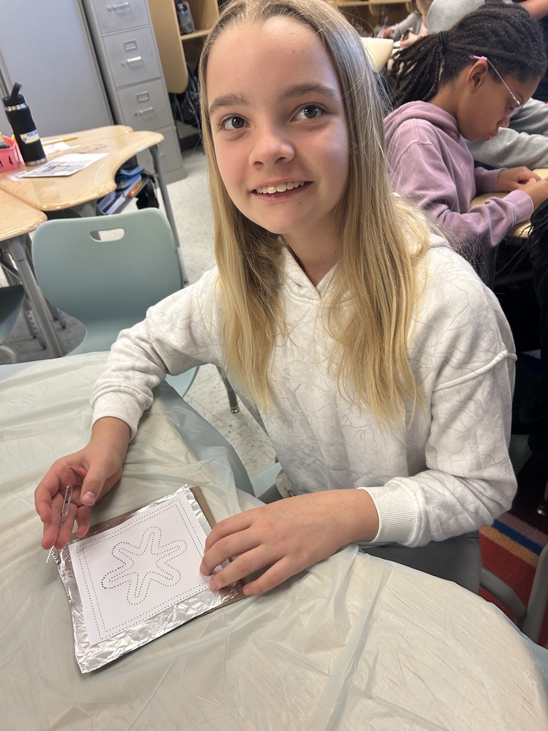 Using patters, students tried out tin art.