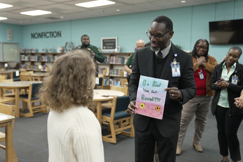 student being shown poster