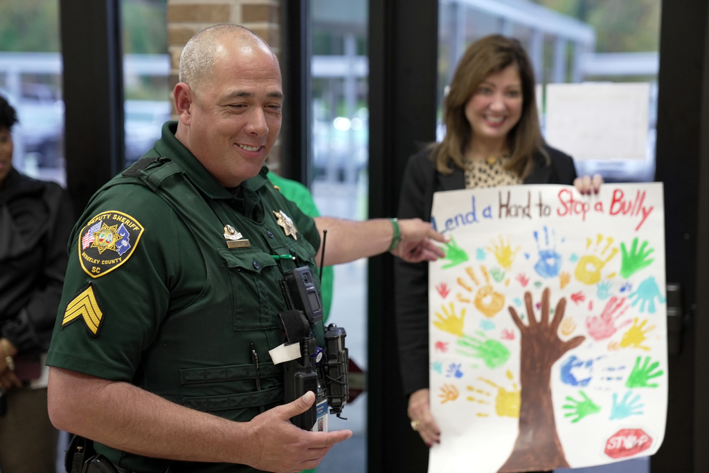 cop pointing to poster