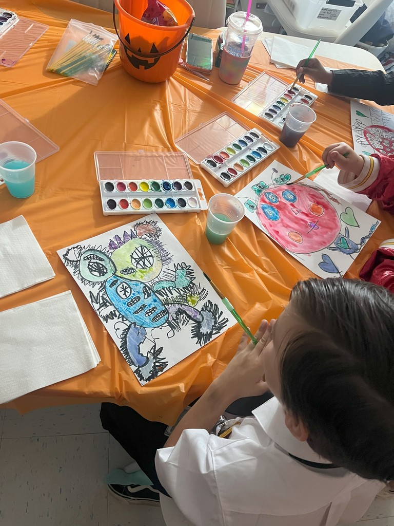 Students using watercolor to to add color to their created monster! 