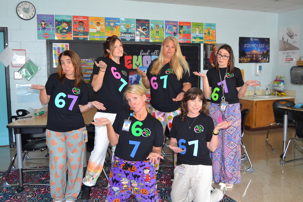 People wearing shirts with 6 7 on them