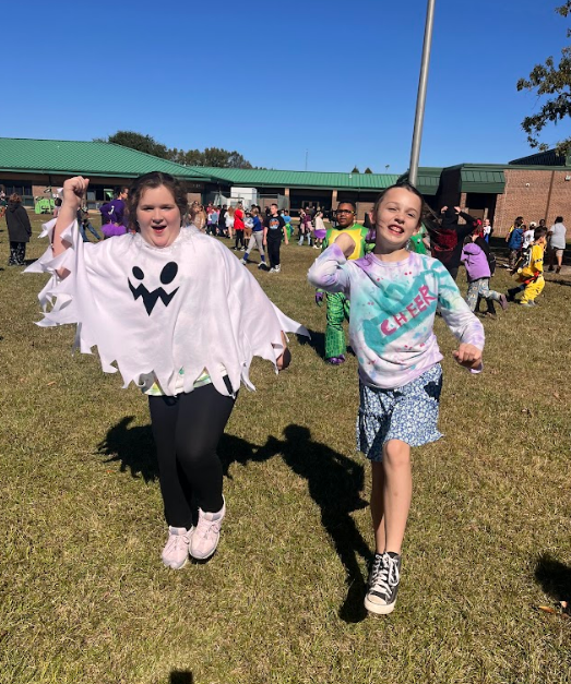 Two girls dancing to celebrate their testing success! One is dressed as a ghost and the other is a cheerleader. 