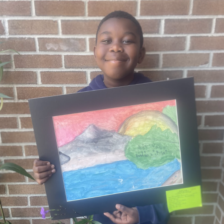 Student holding artwork (watercolor landscape 