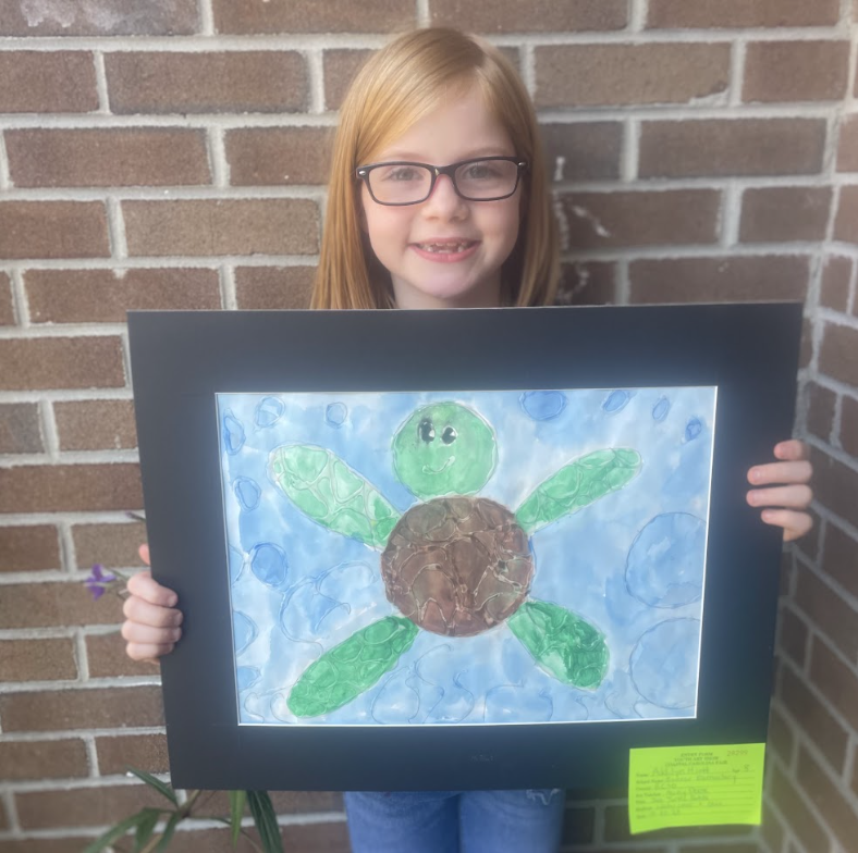 Student holding artwork (water color animal 2) 