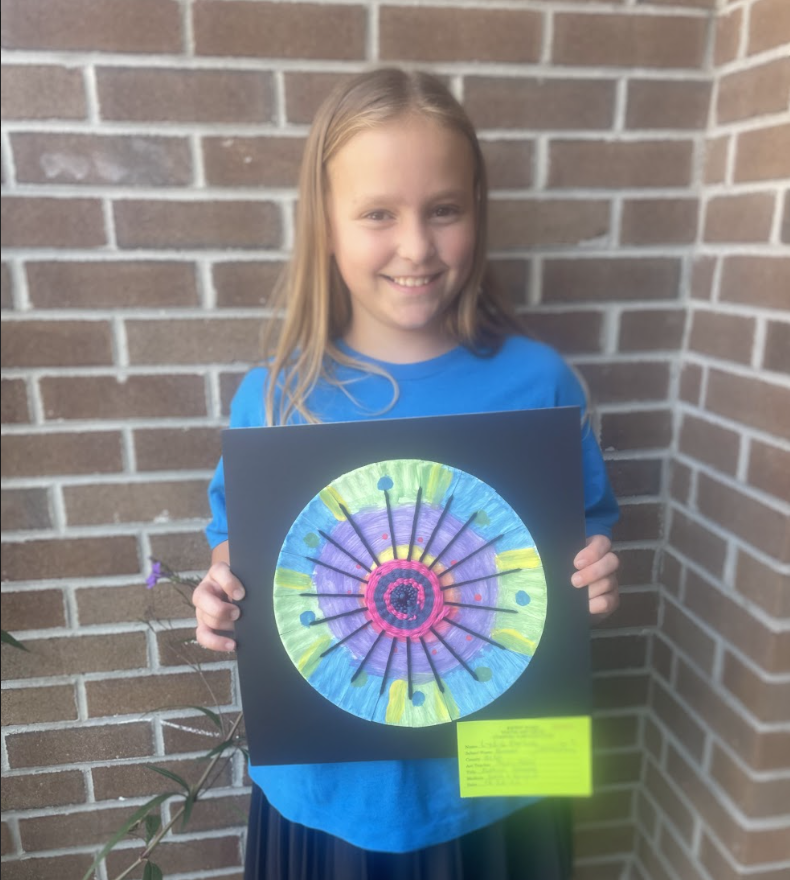 Student holding artwork (weaving pattern 2) 