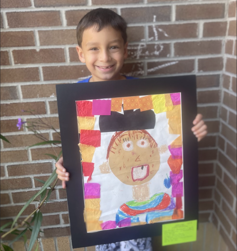 Student holding artwork (self portrait 2) 