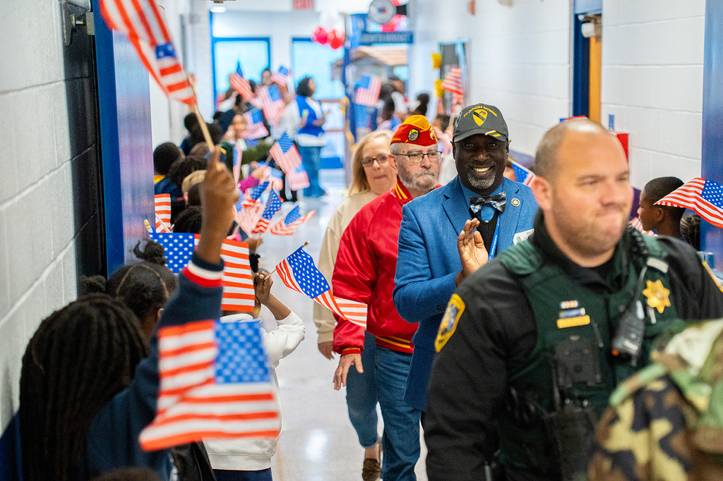 veterans being cheered down the hallway