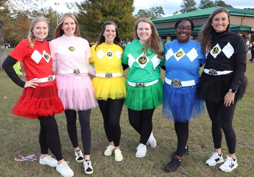 Picture of 6 teachers dressed in power ranger costumes for the event. 