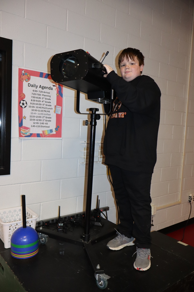 One male student operating the spotlight