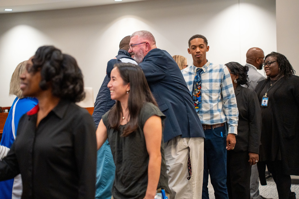 CHS employee hugging board member