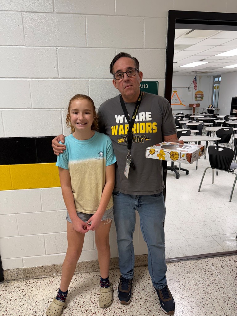Student and teacher pose with winning pie