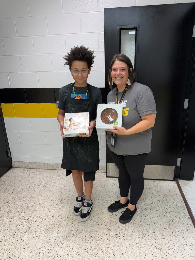 Student and teacher pose with winning pie