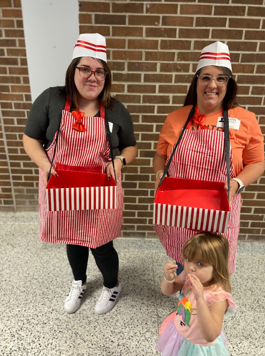 Two volunteers dressed in the popcorn delivery attire to share some goodies with classes.